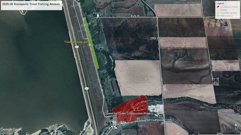 A map with water on the left, grass on the right, and a grey road cutting through the middle.