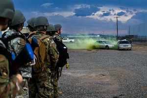 U.S. Air Force Airmen assigned to the 56th Fighter Wing observe a simulated attack during an Ability to Survive and Operate overnight field exercise
