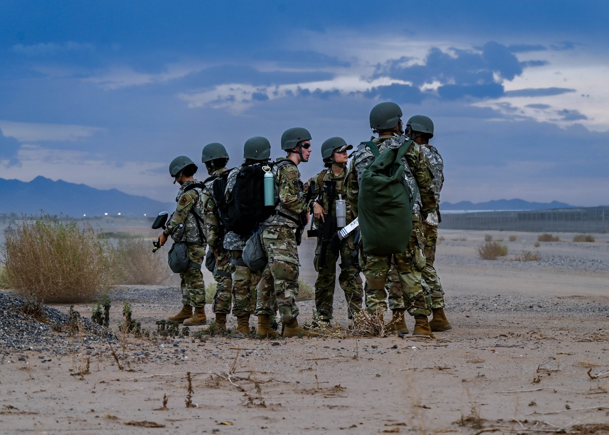 U.S. Air Force Airmen assigned to the 56th Fighter Wing discuss their next steps during an Ability to Survive and Operate overnight field exercise