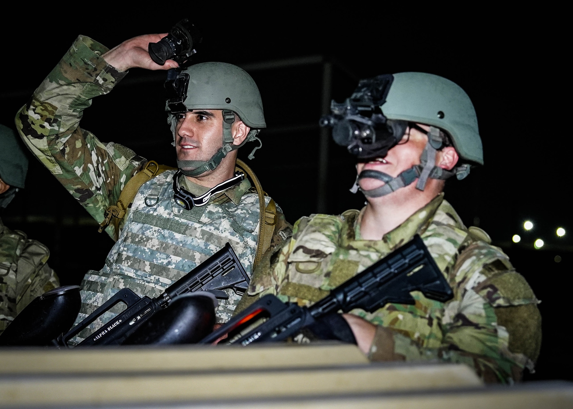 U.S. Air Force Senior Airmen Garrett Rios (left), 56th Equipment Maintenance Squadron Aerospace Ground Equipment specialist, and Justin Davis (right), 756th Aircraft Maintenance Squadron crew chief, maintain security during an Ability to Survive and Operate overnight field exercise
