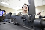 Pfc. Jane Seo, Bravo Company, 832nd Ordnance Battalion, looks up at the instructional TV screen during a demonstration by her instructor during 94T Short Range Air Defense System Repairer Course training Aug. 12. (Terrance Bell)