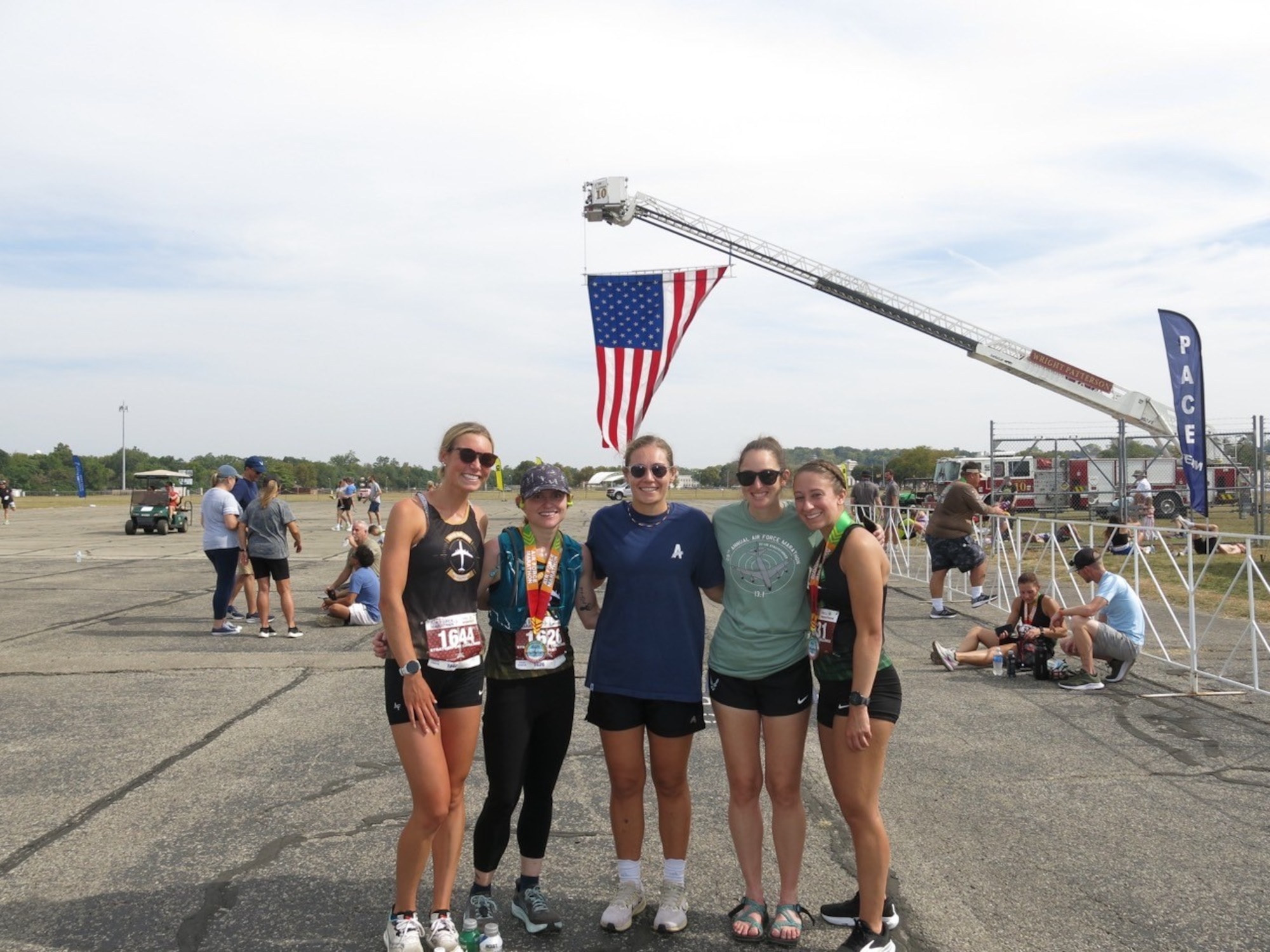 U.S. Air Force Tech. Sgt. Athena Garretson, a 361st Recruiting Squadron enlisted accessions recruiter, and fellow AF Marathon Team members stand together after the marathon events at Wright-Patterson Air Force Base, Ohio, Sept. 20, 2025.
