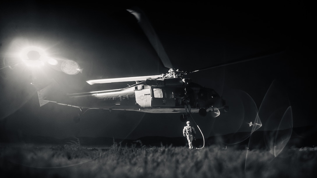A U.S. Marine with the Maritime Raid Force, 11th Marine Expeditionary Unit, clears the area after fast-roping from a U.S. Navy MH-60S Seahawk with Helicopter Sea Combat Squadron (HSC) 21 during helicopter rope suspension techniques training on Marine Corps Base Camp Pendleton, California, Sept. 17, 2025. The HRST training prepares Marines to navigate difficult terrain and enhance air-to-ground insertion capabilities. (U.S. Marine Corps photo by Cpl. Joseph Helms) (This image was taken with a camera altered to capture the infrared spectrum.)