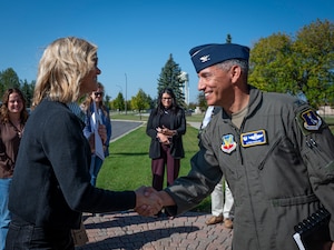 A photo of two people shaking hands.