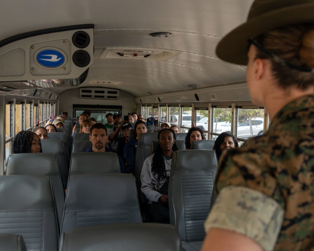 Educators with Recruiting Stations Austin and Albuquerque are given instructions for exiting the bus during Educator's Workshop at Marine Corps Recruit Depot San Diego in San Diego, Calif. on May 26, 2025. The Educators Workshop program provides selected educators and influential community members with the opportunity to see how the Marine Corps transforms young men and women into Marines. The workshop also provides attendees with current information regarding Marine Corps training practices, military job skills, service opportunities, military lifestyle, and educational benefits available to Marines. (U.S. Marine Corps photo by Sgt. Jose D. Cruz )