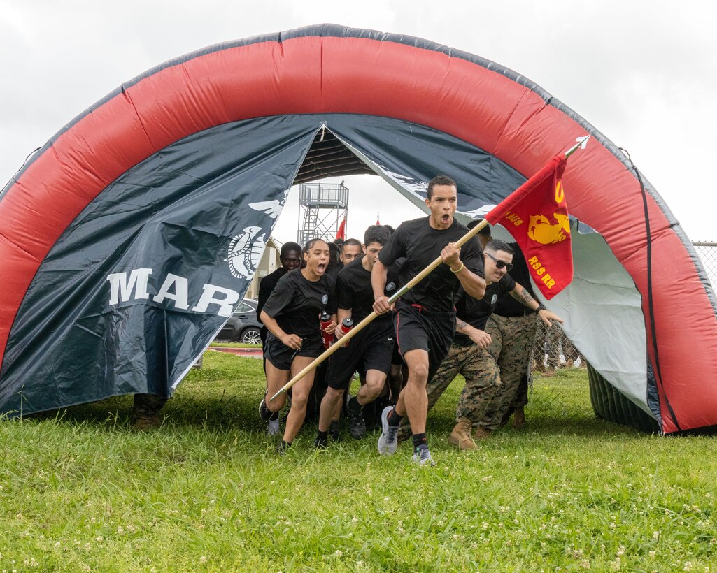 U.S. Marines and poolees with Recruiting Sub-Station Round Rock, Recruiting Station (RS) Austin, 8th Marine Corps District, enter Stony Point High School football field during RS Austin's annual pool function at Stony Point High School, Round Rock, Texas, April 25, 2025. Annual pool functions serve as an opportunity for future Marines and family members to view and receive a firsthand experience of some of the rigors they will face in recruit training while providing an opportunity for team building and education as well as time for questions and answers. (U.S. Marine Corps photo by Cpl. Jose D. Cruz)