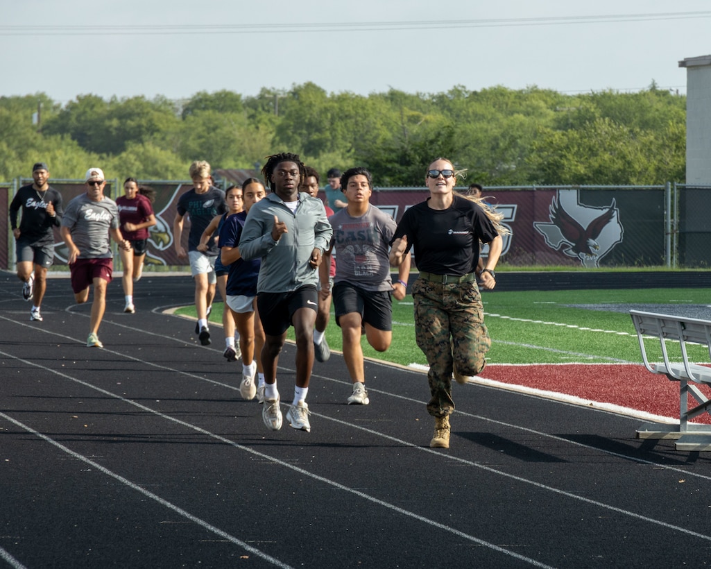 Hillsboro High School students and coaches execute an 880-yard sprint at Hillsboro High School in Hillsboro, Texas, July 16, 2025. The CFT assesses a Marine’s ability to perform high-intensity combat-related tasks and consists of three events: movement to contact, ammunition can lift, and the maneuver under fire. (U.S. Marine Corps photo by Sgt. Jose D. Cruz)