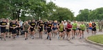 U.S. Army Soldiers assigned to the Vermont National Guard, run in the Vermont Remembers Run 2025 with community members at Camp Johnson.