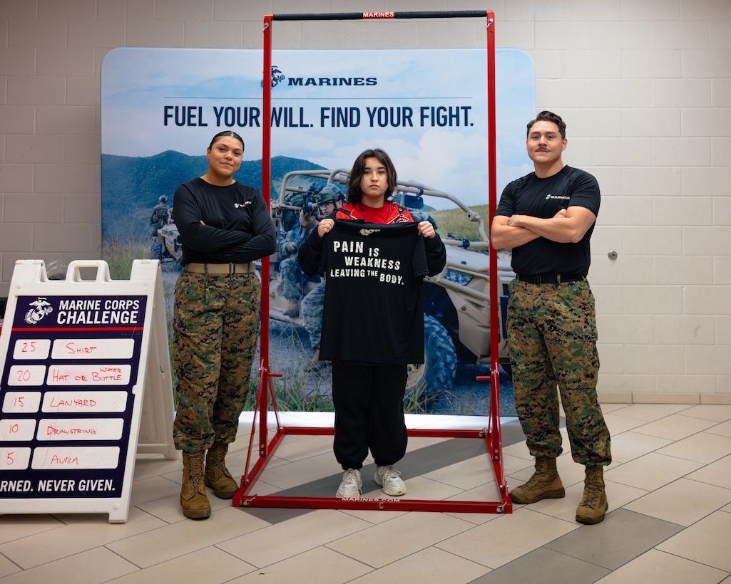 U.S. Marine Corps recruiters with Recruiting Sub-Station Lewisville, Recruiting Station Fort Worth pose for a photo with a high school student during the Coppell independent school district regional tournament at Coppell High School, Coppell, Texas, Feb. 7, 2025. U.S. Marines with Recruiting Sub-Station Lewisville sponsored the tournament to increase awareness and community engagement. (U.S. Marine Corps photo by Sgt. Jaiden O. Sangster)