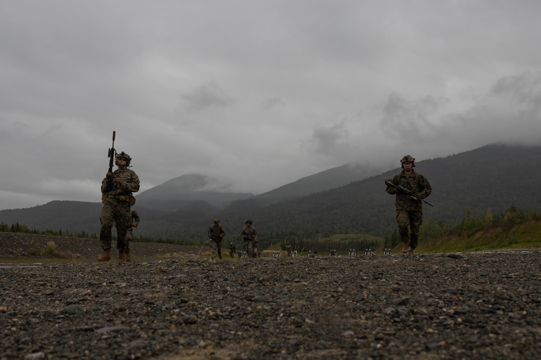 U.S. Marines with Kilo Company, 3rd Battalion, 4th Marine Regiment, 1st Marine Division and Detachment Delta Company, 4th Law Enforcement Battalion, Marine Corps Forces Reserve, run through a course of fire during a range as part of ARCTIC EDGE 2025 (AE25) on Joint Base Elmendorf-Richardson, Aug. 19, 2025. AE25 is a NORAD and U.S. Northern Command-led homeland defense exercise designed to improve readiness, demonstrate capabilities, and enhance Joint and Allied Force interoperability in the Arctic. (U.S. Marine Corps photo by Cpl. Jaye Townsend)