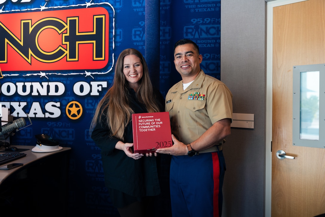 U.S. Marine Corps Maj. John Garcia, the commanding officer of Recruiting Station Fort Worth, poses for a photo with Lindsey Hoover, morning show host for 95.9 The Ranch after an interview in Fort Worth, Texas, July 10, 2025. The interview builds community relationships and highlights the upcoming celebration of the Marine Corps' 250th birthday. (U.S. Marine Corps photo by Sgt. Jaiden O. Sangster)