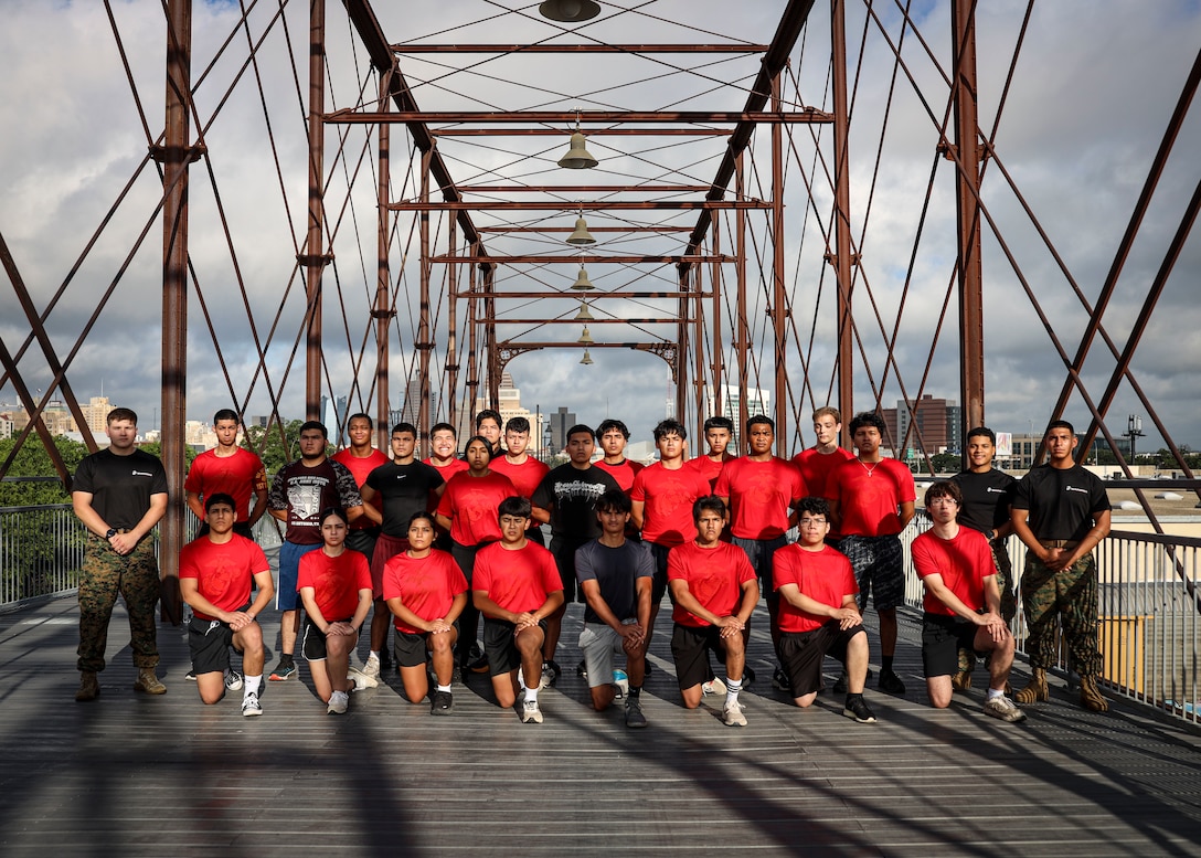 U.S. Marines and Marine Corps Poolees with Recruiting Sub-Station South Park, Recruiting Station San Antonio, pose for a group photo after a physical training session in San Antonio, Texas, June 26, 2025. Physical training sessions are conducted to enhance unit morale and foster camaraderie. (U.S. Marine Corps photo by Sgt. Jacqueline Peguero-Montes)