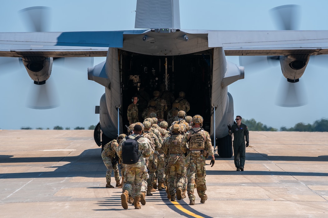 U.S. Airmen assigned to the 509th Security Forces Squadron board a C-130 Hercules aircraft from Rosecrans Air National Guard Base, Missouri, at Whiteman Air Force Base, Missouri, Aug. 8, 2025. The Airmen participated in a high-value individual transfer exercise where they had to escort a subject on an aircraft and to a destination in a simulated contested area. (U.S. Air Force photo by Staff Sgt. Joshua Hastings)