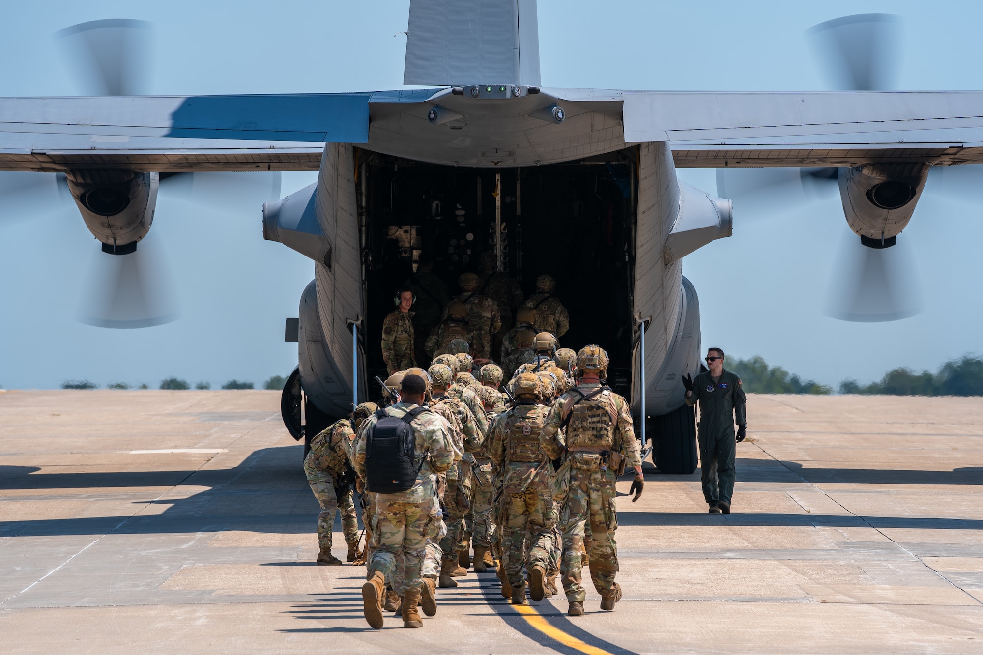 U.S. Airmen assigned to the 509th Security Forces Squadron board a C-130 Hercules aircraft from Rosecrans Air National Guard Base, Missouri, at Whiteman Air Force Base, Missouri, Aug. 8, 2025. The Airmen participated in a high-value individual transfer exercise where they had to escort a subject on an aircraft and to a destination in a simulated contested area. (U.S. Air Force photo by Staff Sgt. Joshua Hastings)