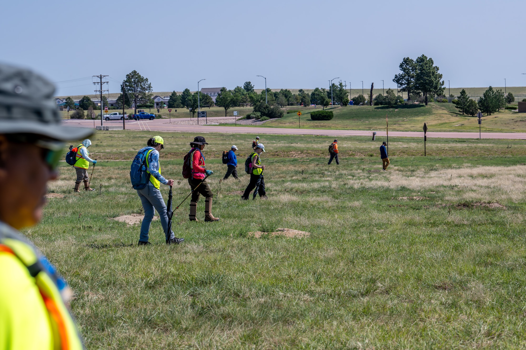 Tribal Cultural Specialists survey a large open space looking for areas of cultural or religious significance near the western perimeter of Schriever Space Force Base.