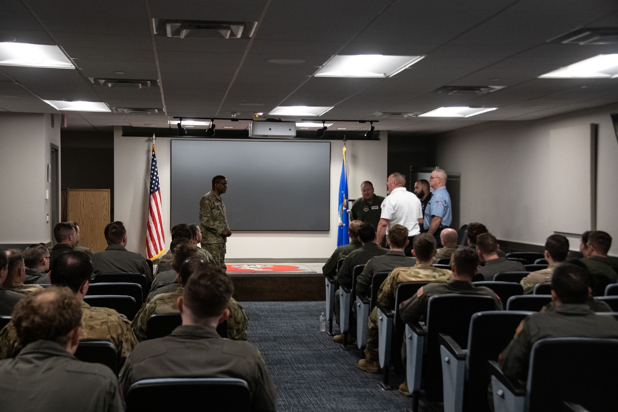 People stand in a room.