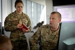Senior Master Sgt. Ryan Garbers speaks with members of his team from the Lincoln-based 155th Communications Squadron, Nebraska Air National Guard, as they attempt to identify and isolate a possible intrusion into their "network" during the second week of the Cyber Tatanka exercise held on the University of Nebraska-Lincoln campus in Lincoln, Nebraska. The exercise enabled network defense specialists representing military, governmental and private organizations to refine their cyber defense skills in a realistic yet safe environment on the exercise's "cyber ranges."