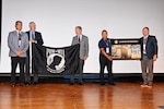 Jon Figuerres, a member of the academy’s class of 1985 and the Defense POW/MIA Accounting Agency senior operations officer, was given an award during the Naval Academy 40th class reunion, Sept. 19, 2025, in Annapolis, Md.