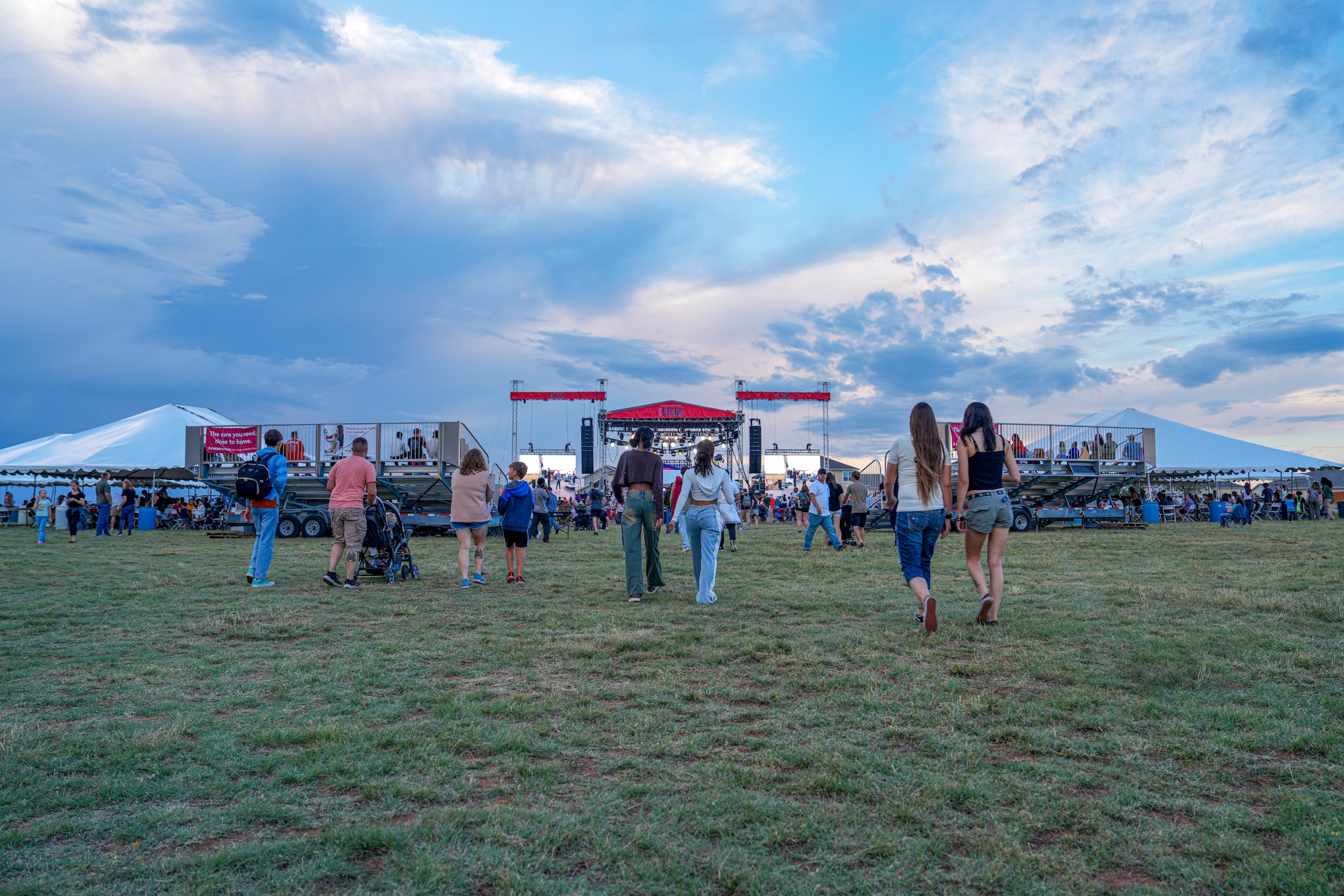 Air Commandos gather near the stage in anticipation of the Fall Fest performances at Cannon Air Force Base, New Mexico, Sept. 19, 2025. Fall Fest stands as the biggest event of the year, improving the quality of life for Air Commandos and their families. (U.S. Air Force photo by Airman 1st Class Gracelyn Hess)