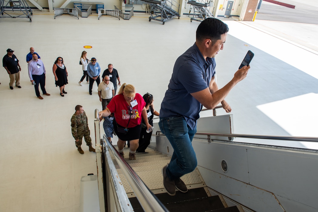 Honorary commanders board an aircraft