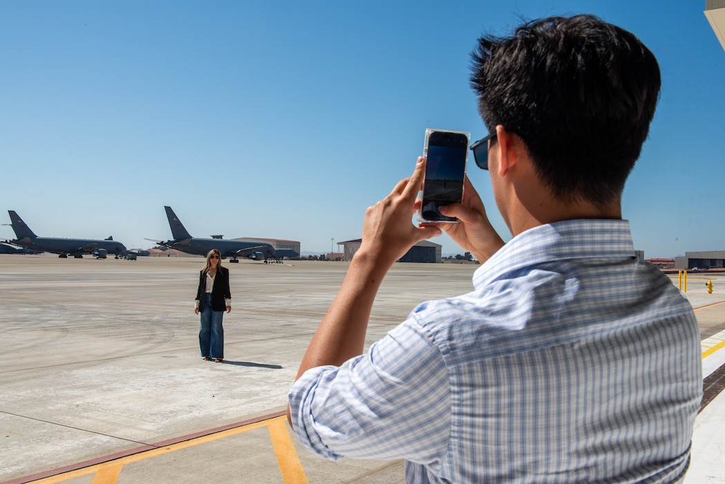 Honorary commander takes a photo on the flight line