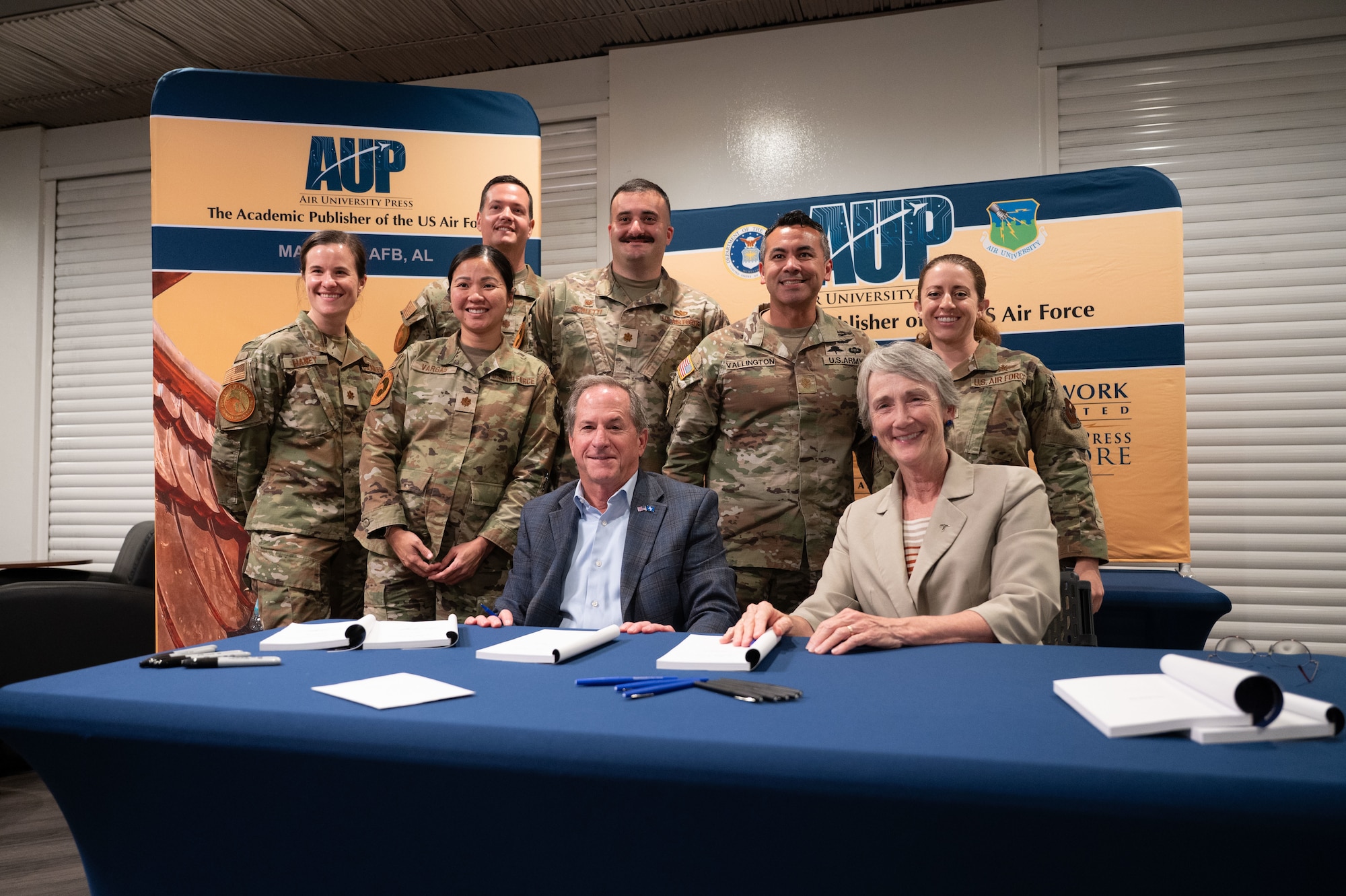 Retired Gen. David Goldfein, former Air Force Chief of Staff, and former Secretary of the Air Force Heather Wilson pose for a photograph with U.S. service members at the Squadron Officer School on Maxwell Air Force Base, Alabama, Sept. 29, 2025.