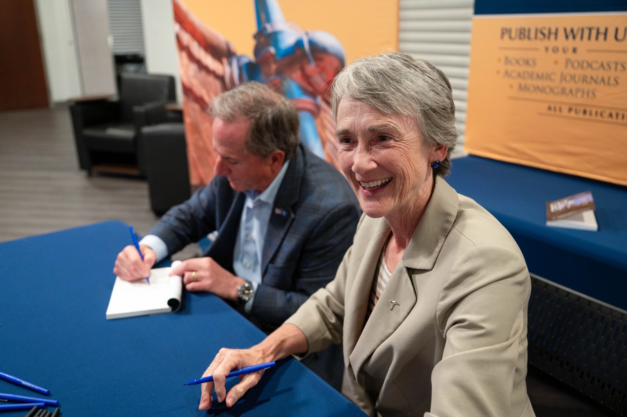 Former Secretary of the Air Force Heather Wilson and retired Gen. David Goldfein, former Air Force Chief of Staff, sign books at the Squadron Officer School on Maxwell Air Force Base, Alabama, Sept. 29, 2025.