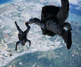 U.S. Marines with Force Reconnaissance Platoon, Maritime Raid Force, 31st Marine Expeditionary Unit, conduct a freefall jump during parachute operations training over Okinawa, Japan, Sep. 26, 2025.