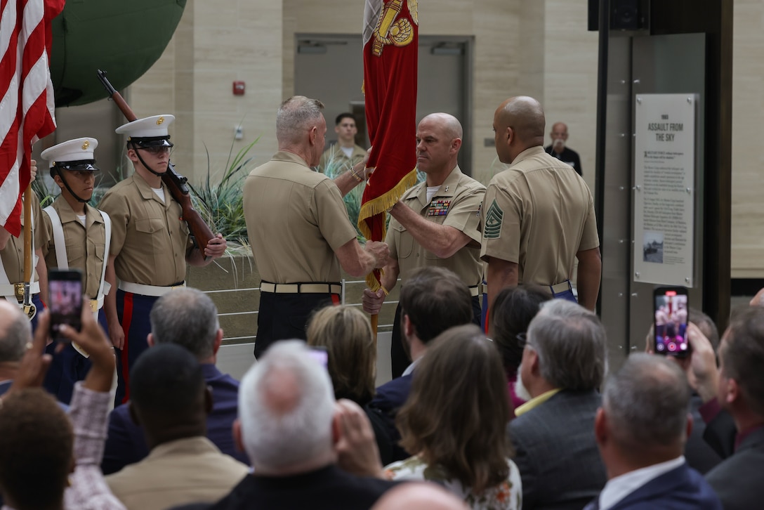 U.S. Marine Corps Maj. Gen. Walker M. Field, commanding general of Marine Corps Recruiting Command, receives the colors from Lt. Gen. William J. Bowers, deputy commandant of Manpower and Reserve Affairs, during a change of command ceremony at the National Museum of the Marine Corps, Triangle, Va., Sept. 30, 2025. Passing the colors in a change of command ceremony is a symbolic transfer of authority, responsibility, and trust from an outgoing commander to an incoming commander. (U.S. Marine Corps photo by Cpl. Brenna Ritchie)