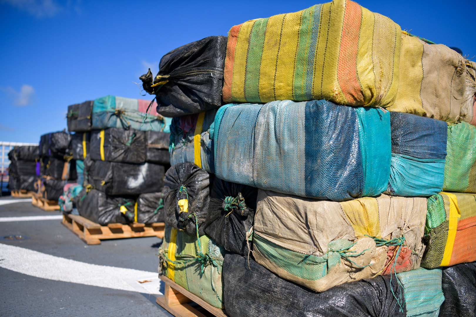 More than 12,750 pounds of cocaine and marijuana are stacked on pallets aboard USCGC Seneca (WMEC 906) to be offloaded at Port Everglades in Fort Lauderdale, Florida, Sept. 30, 2025. Seneca is a Famous Class medium endurance cutter homeported in Portsmouth, Virginia. (U.S Coast Guard photo by Petty Officer 1st Class Diana Sherbs)