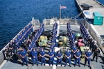 The crew of USCGC Seneca (WMEC 906) stand for a photo during a drug offload at Port Everglades in Fort Lauderdale, Florida, Sept. 30, 2025. The crew offloaded more than 12,750 pounds of cocaine and marijuana with an approximate street value of $94.5 million. (U.S. Coast Guard photo by Petty Officer 1st Class Diana Sherbs)