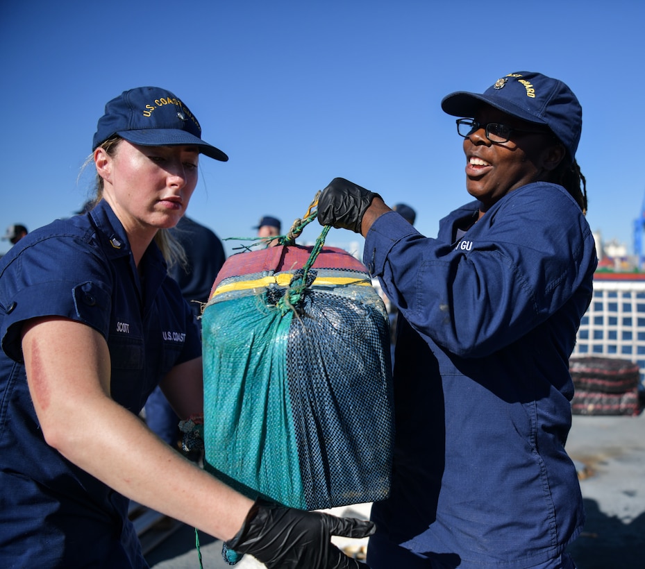 Crew members aboard USCGC Seneca (WMEC 906) stack bales of illicit narcotics on pallets to be offloaded at Port Everglades in Fort Lauderdale, Florida, Sept. 30, 2025. The crew offloaded more than 12,750 pounds of cocaine and marijuana with an approximate street value of $94.5 million. (U.S. Coast Guard photo by Petty Officer 1st Class Diana Sherbs)