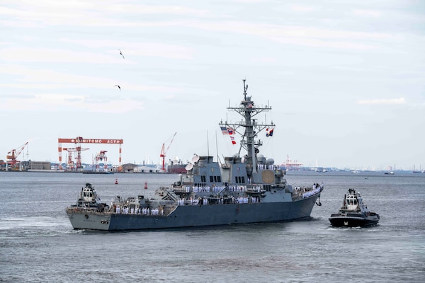 Sailors assigned to the Arleigh Burke-class guided-missile destroyer USS Benfold (DDG 65) man the rails as the ship departs Commander, Fleet Activities Yokosuka, Japan, Sept. 29, following 10 consecutive years of forward-deployed service in the U.S. 7th Fleet area of operations.