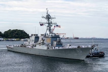 Sailors assigned to the Arleigh Burke-class guided-missile destroyer USS Benfold (DDG 65) man the rails as the ship departs Commander, Fleet Activities Yokosuka, Japan, Sept. 29, following 10 consecutive years of forward-deployed service in the U.S. 7th Fleet area of operations.