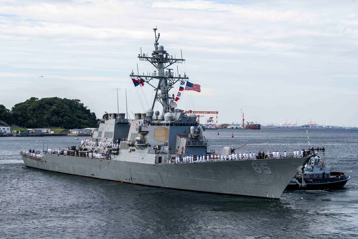 Sailors assigned to the Arleigh Burke-class guided-missile destroyer USS Benfold (DDG 65) man the rails as the ship departs Commander, Fleet Activities Yokosuka, Japan, Sept. 29, following 10 consecutive years of forward-deployed service in the U.S. 7th Fleet area of operations.