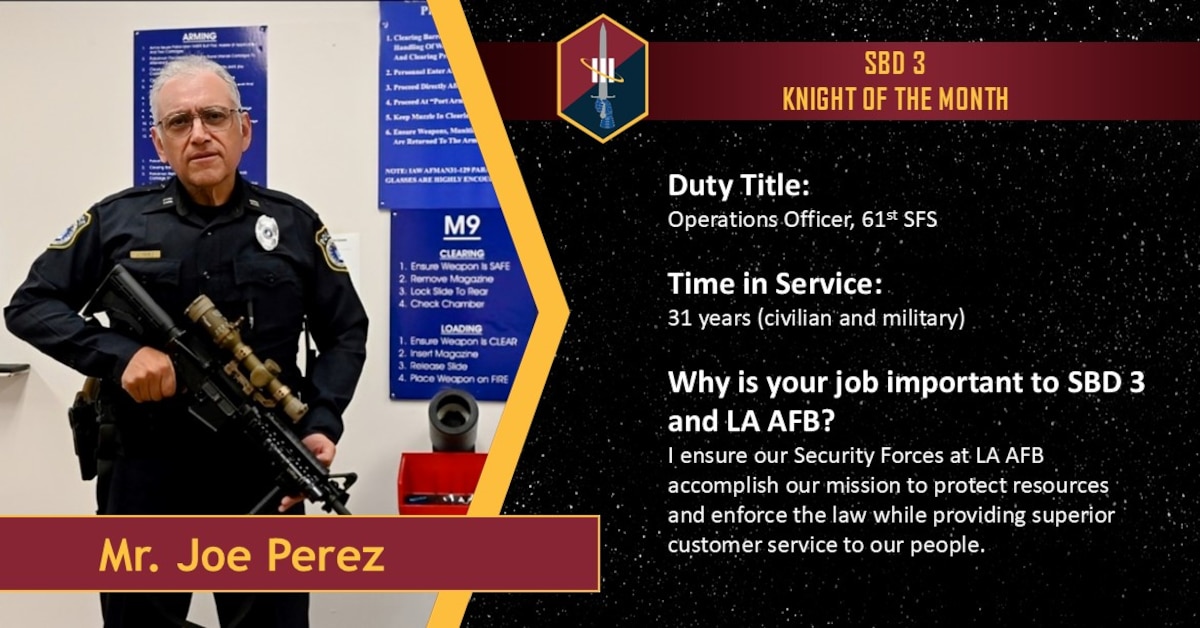 A police officer poses with an unloaded rifle as he is recognized as Space Base Delta 3 October 2025 Knight of the Month