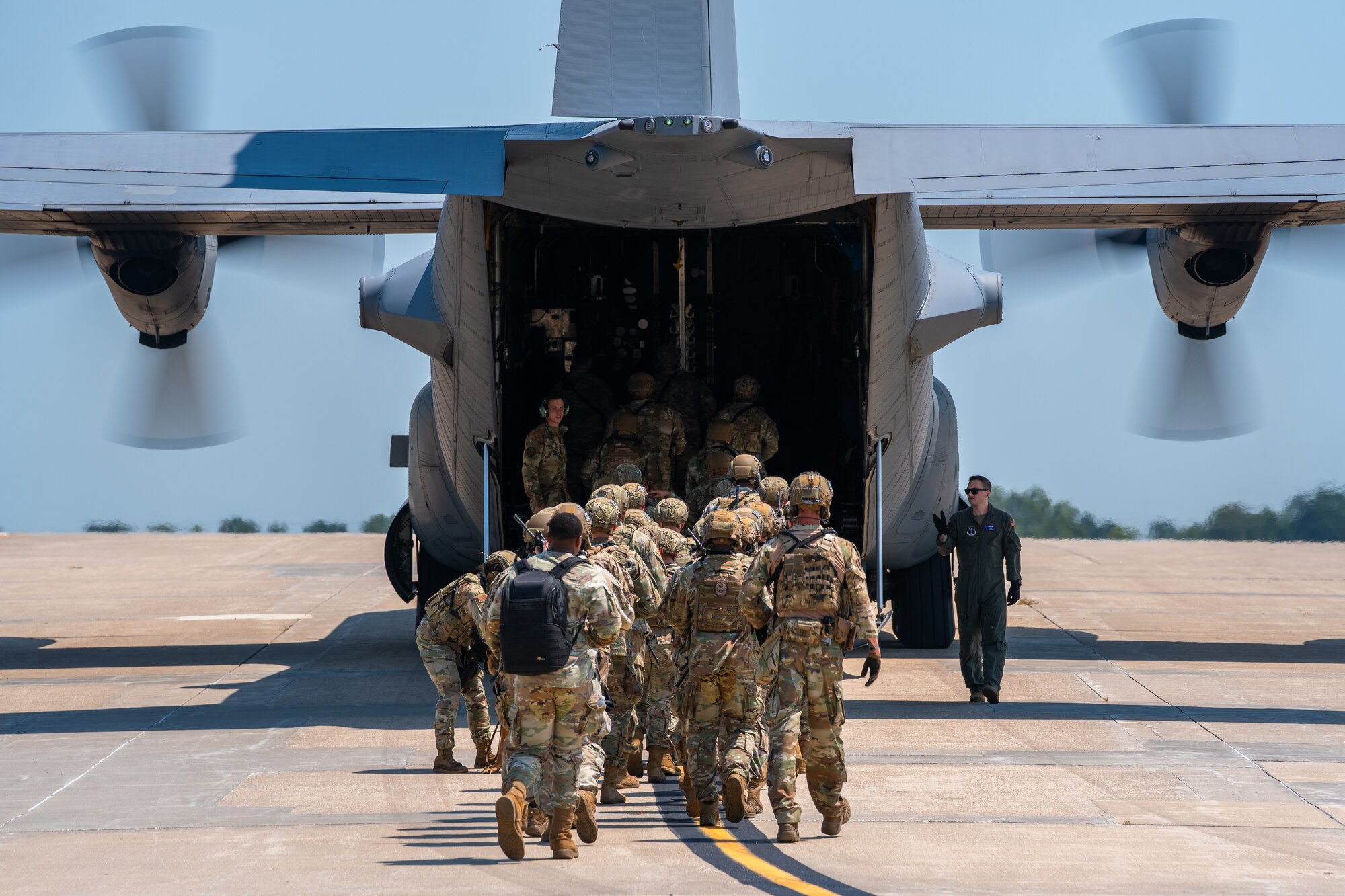 U.S. Airmen assigned to the 509th Security Forces Squadron board a C-130 Hercules aircraft from Rosecrans Air National Guard Base, Missouri, at Whiteman Air Force Base, Missouri, Aug. 8, 2025. The Airmen participated in a high-value individual transfer exercise where they had to escort a subject on an aircraft and to a destination in a simulated contested area. (U.S. Air Force photo by Staff Sgt. Joshua Hastings)