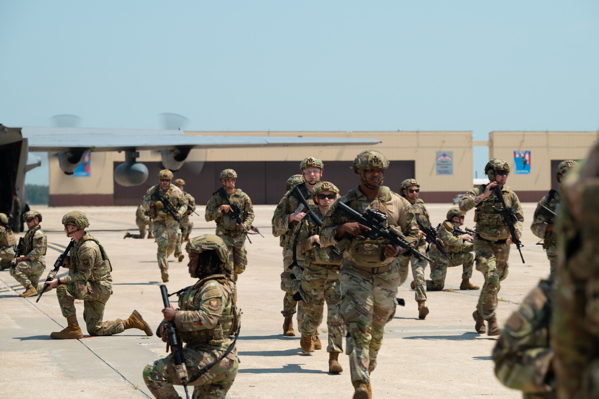 U.S. Airmen assigned to the 509th Security Forces Squadron deboard a C-130 Hercules aircraft from Rosecrans Air National Guard Base, Missouri, during a high-value individual transfer exercise at Whiteman Air Force Base, Missouri, Aug. 8, 2025. The training prepared the Airmen for effective escort of an HVI in a contested environment. (U.S. Air Force photo by Senior Airman Joseph Garcia)