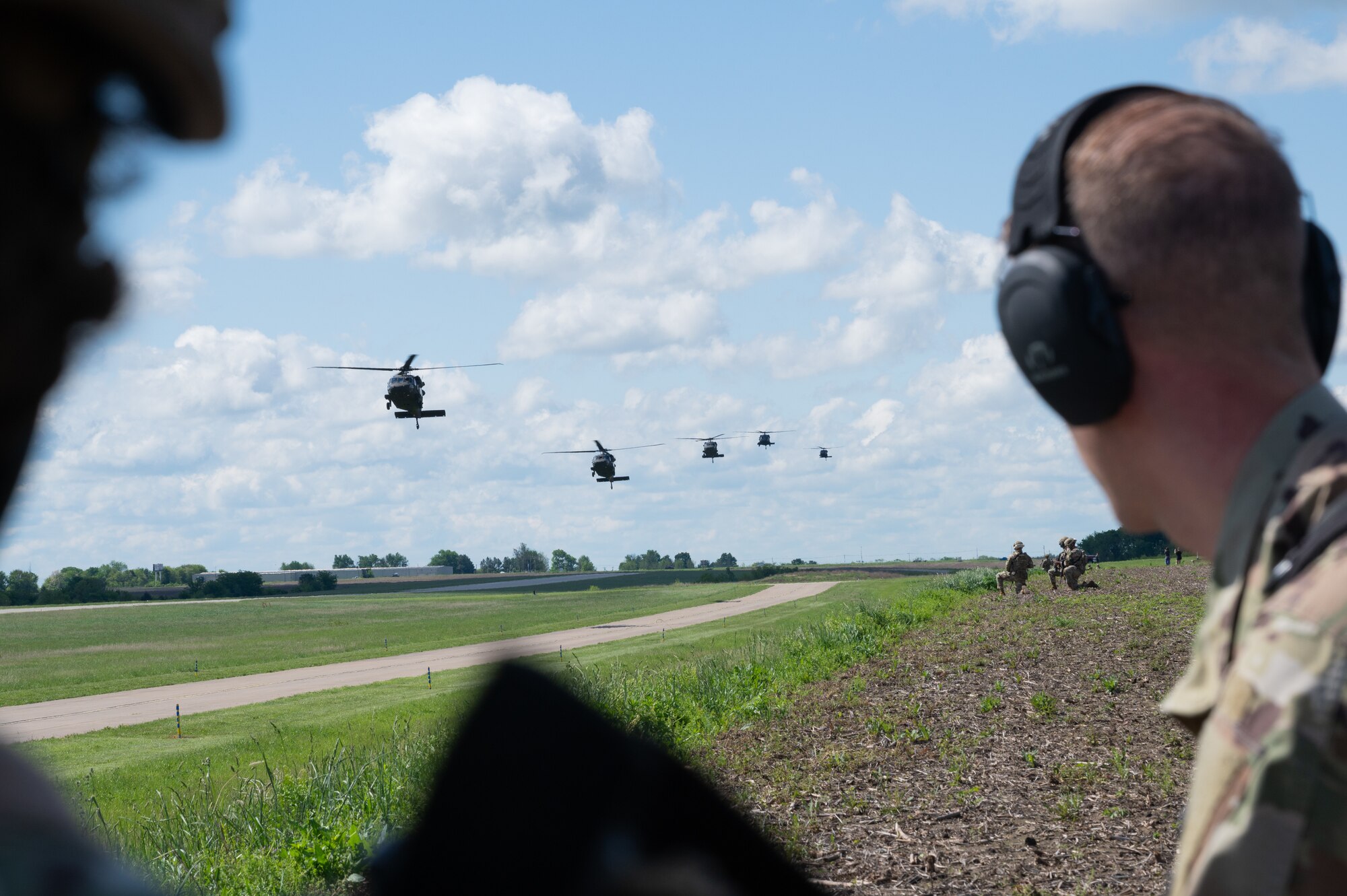 Five UH-60 Black Hawk helicopters piloted by the Missouri Army National Guard 1-135 Assault Helicopter Battalion land at Sedalia Regional Airport, Missouri, May 4, 2025. The battalion supported a joint force exercise with defenders assigned to the 509th Security Forces Squadron from Whiteman Air Force Base, Missouri. (U.S. Air Force photo by Senior Airman Joseph Garcia)