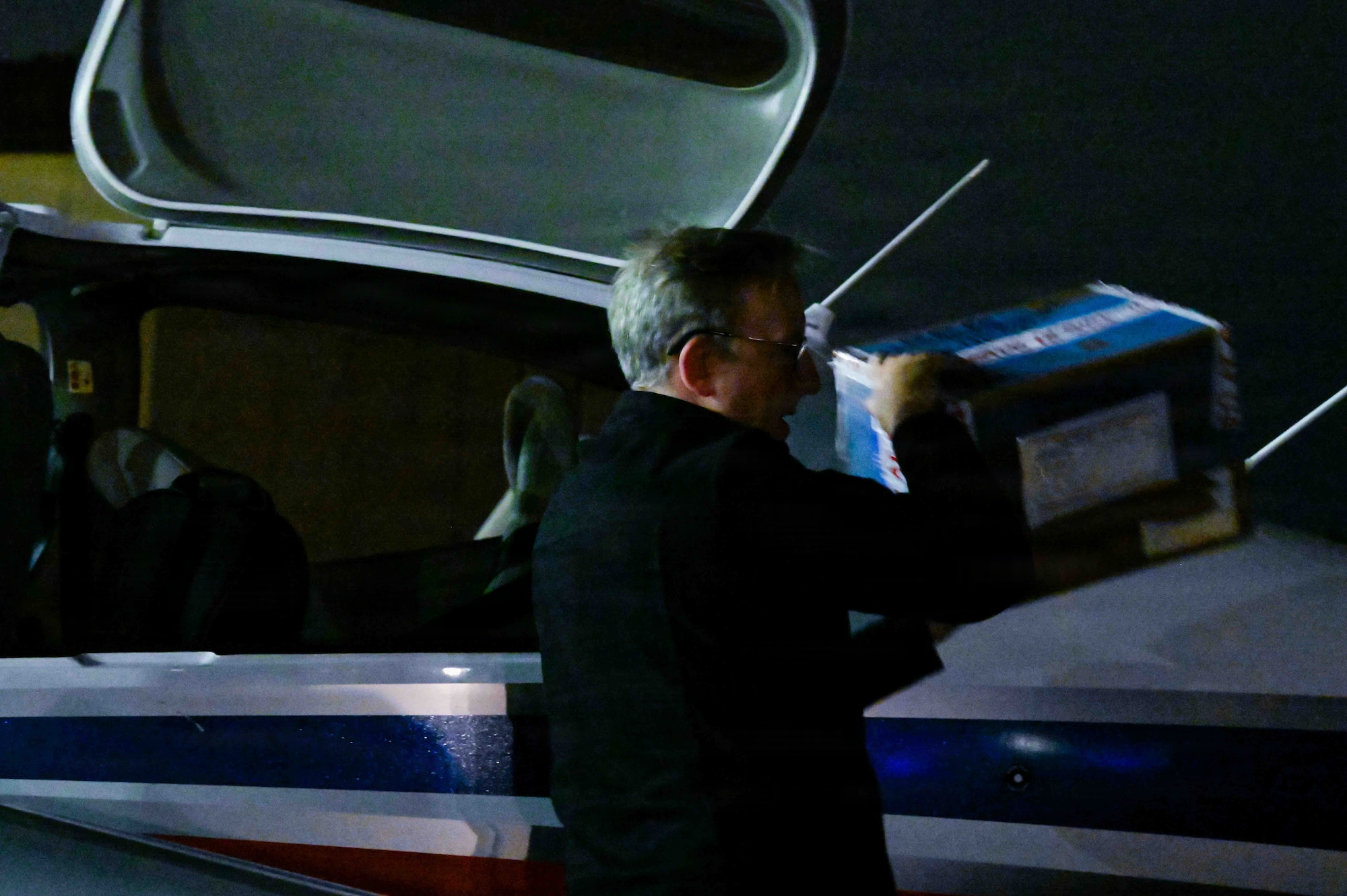 Jake Kadish, Yokota Flight Center chief instructor, retrieves simulated repair parts from a Diamond DA42 NG twinstar assigned to the YFC during a small parts delivery mission as part of exercise Beverly Midnight 2026 at Yokota Air Base, Japan, March 13, 2026. This exercise provides unique opportunities to synchronize and integrate various forces across Japan into joint, coalition and bilateral training from simulated forward operating bases.