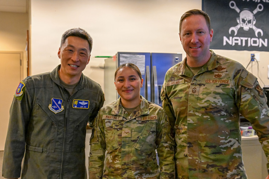 U.S. Air Force Airman 1st Class Natalie Martinez, poses for a photo with base leadership.