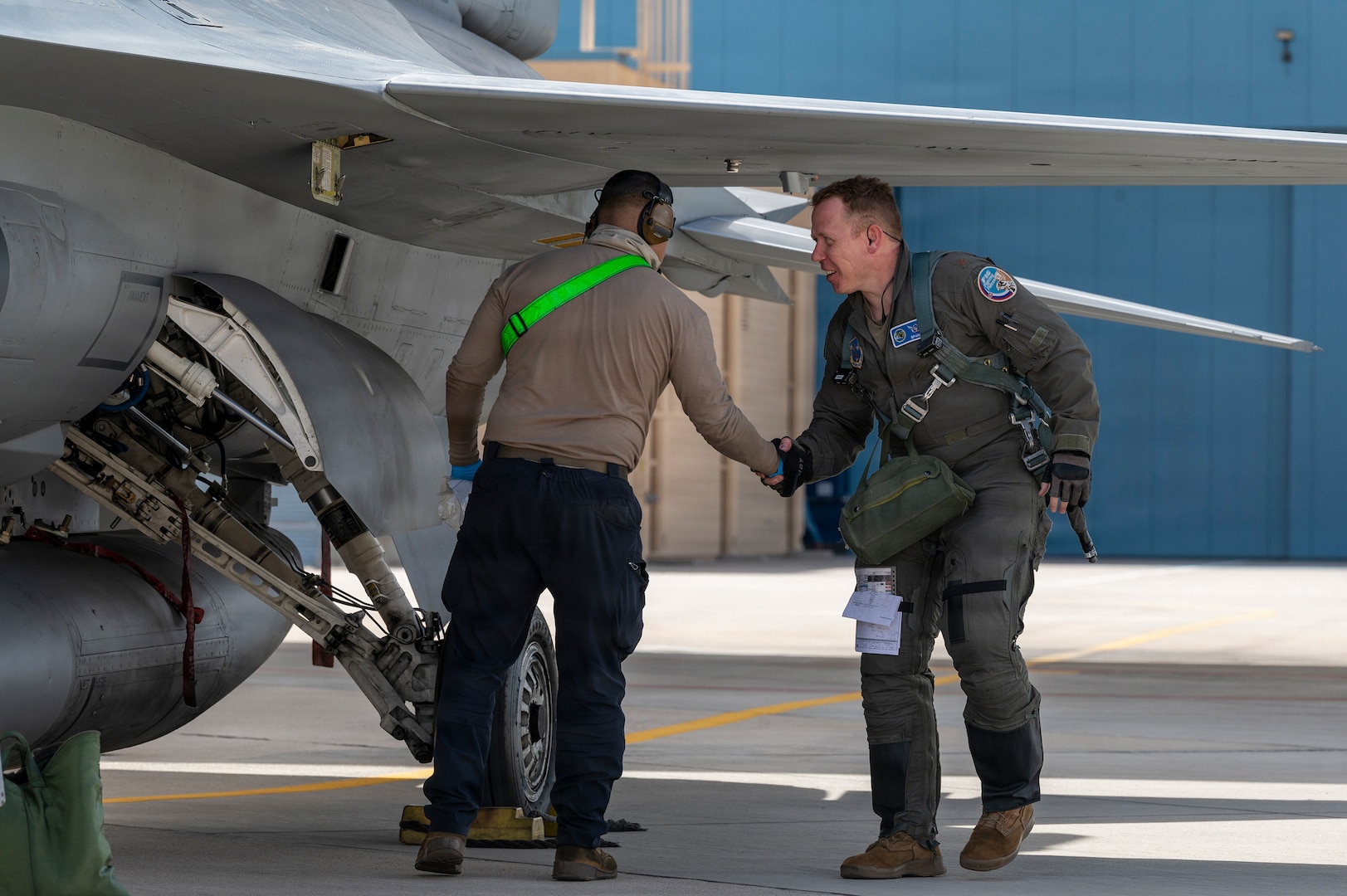 A F-16 Fighting Falcon aircraft pilot assigned to the Slovak Armed Forces shakes hands with a U.S. Air Force crew chief after a joint training flight at Morris Air National Guard Base, Tucson, Arizona, Feb. 15, 2026.