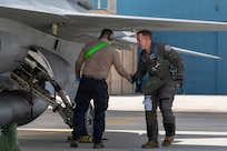 A F-16 Fighting Falcon aircraft pilot assigned to the Slovak Armed Forces shakes hands with a U.S. Air Force crew chief after a joint training flight at Morris Air National Guard Base, Tucson, Arizona, Feb. 15, 2026.