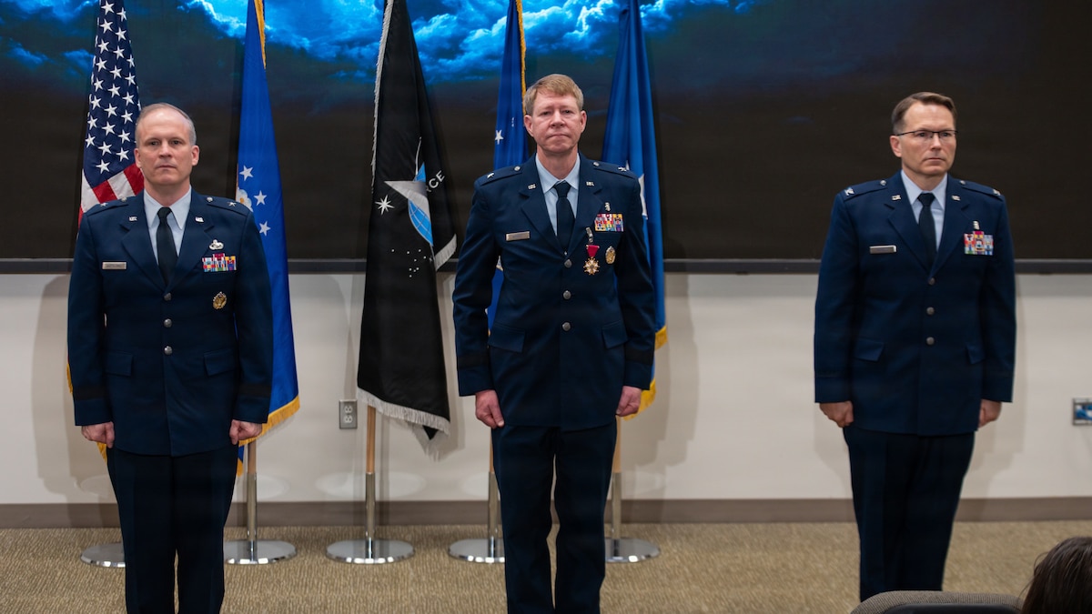 From left: Brig. Gen. Jason Bartolomei, Air Force Research Laboratory (AFRL) commander; Brig. Gen. (Dr.) Robert Bogart, outgoing 711th Human Performance Wing commander; and Col. Dale Harrell, incoming 711th Human Performance Wing commander; stand before the audience during a change of command ceremony at Wright-Patterson Air Force Base, Ohio, March 30, 2026.
