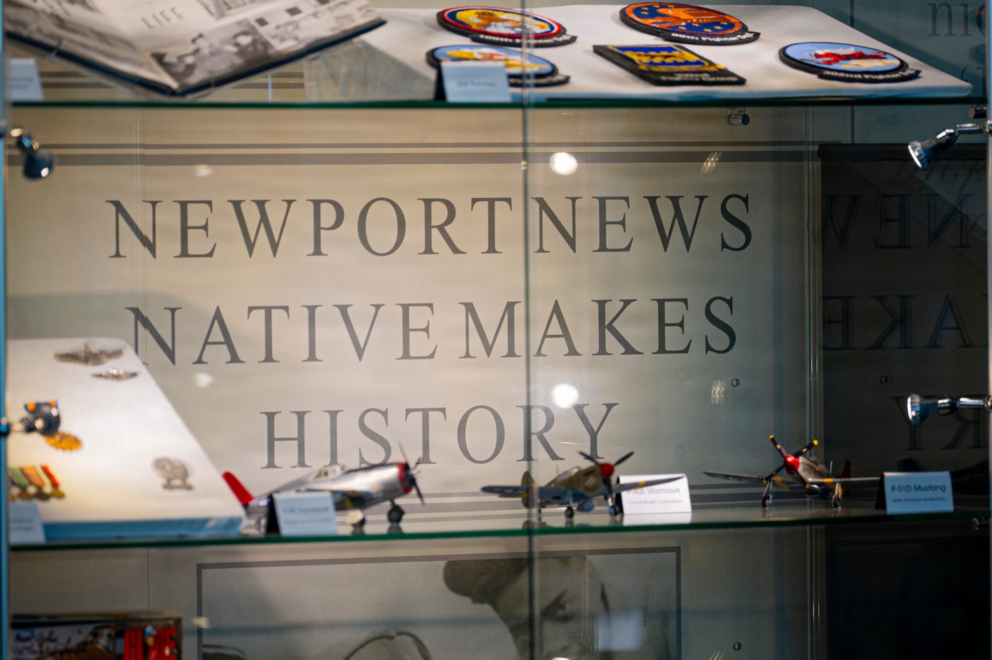 A display case sits static at the new Tuskegee Airmen exhibit at the Virginia Air and Space Science Center in Hampton, Virginia, March 26, 2026. The case contains memorabilia of the 332d Fighter Group, bringing a new piece of Air Force history to the Hampton Roads area. (U.S. Air Force photo by Staff Sgt. Michael Bowman)
