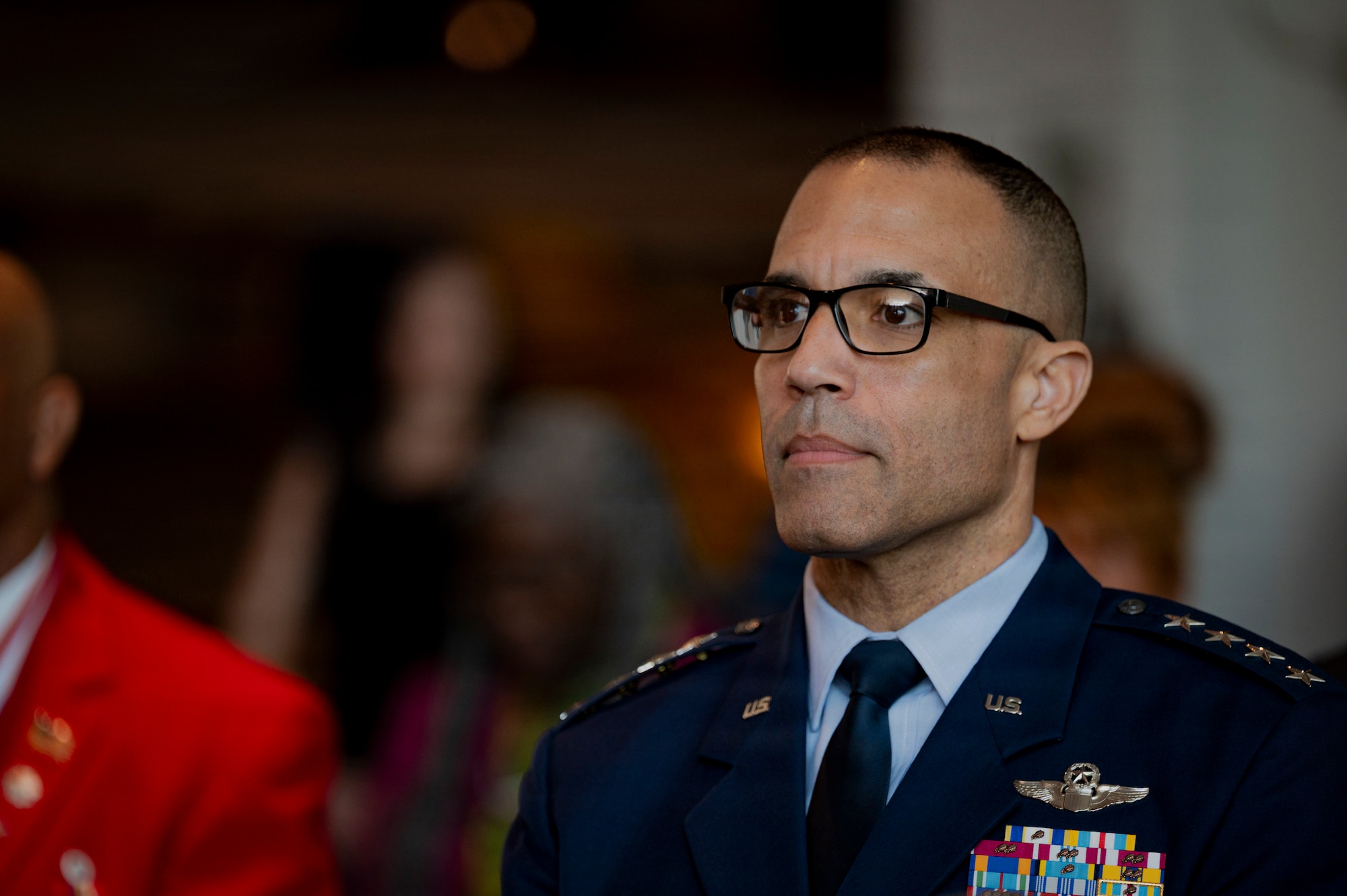 U.S. Air Force Gen. Adrian Spain, commander of Air Combat Command, listens during the grand opening of the new Tuskegee Airmen exhibit at the Virginia Air and Space Science Center in Hampton, Virginia, March 26, 2026. The opening ceremony contained remarks by U.S. Army Air Forces Sergeant (former) Thomas Newton, Documented Original Tuskegee Airman, Gen. Spain, and other distinguished guests before the ribbon cutting. (U.S. Air Force photo by Staff Sgt. Michael Bowman)