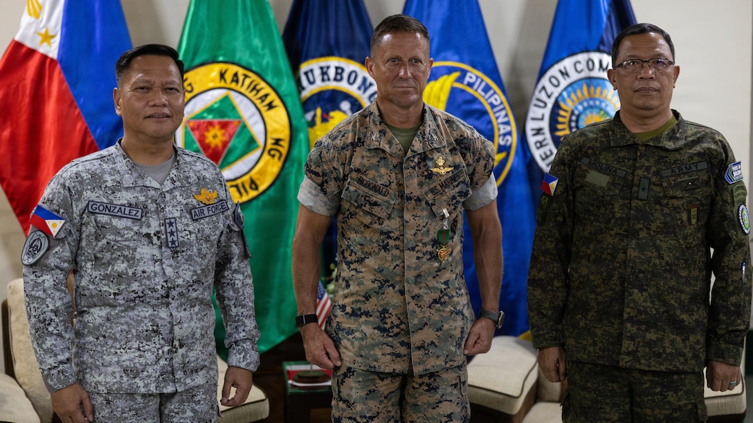 U.S. Marine Corps Col. Robb T. McDonald, center, the outgoing commanding officer of Marine Rotational Force – Southeast Asia, I Marine Expeditionary Force, poses for a photo with Philippine Air Force Lt. Gen. Aristotle D. Gonzalez, left, the commanding general of Northern Luzon Command and Brig. Gen. Cesar A. Molina, the deputy commander of NOLCOM, during a key leader engagement at Camp Aquino, Clark, Philippines.