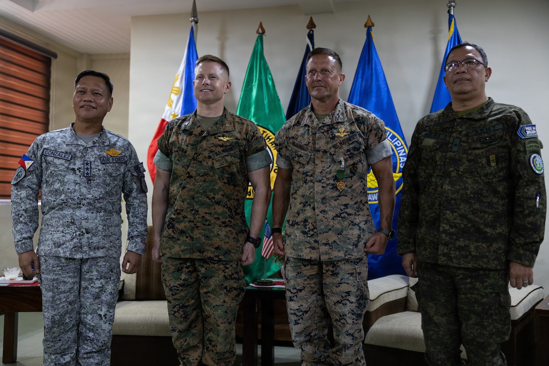 U.S. Marine Corps Col. Robert S. Bunn, center left, the incoming commanding officer of Marine Rotational Force – Southeast Asia, I Marine Expeditionary Force, and Col. Robb T. McDonald, the outgoing commanding officer of MRF-SEA, pose for a photo with Philippine Air Force Lt. Gen. Aristotle D. Gonzalez, left, the commanding general of Northern Luzon Command, and Brig. Gen. Cesar A. Molina, the deputy commander of NOLCOM, during a key leader engagement at Camp Aquino, Philippines.