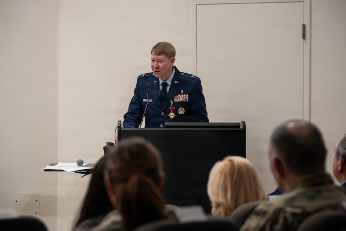 Brig. Gen. (Dr.) Robert Bogart, outgoing 711th Human Performance Wing commander, speaks during Col. Dale Harrell’s change of command ceremony at Wright-Patterson Air Force Base, Ohio, March 30, 2026.