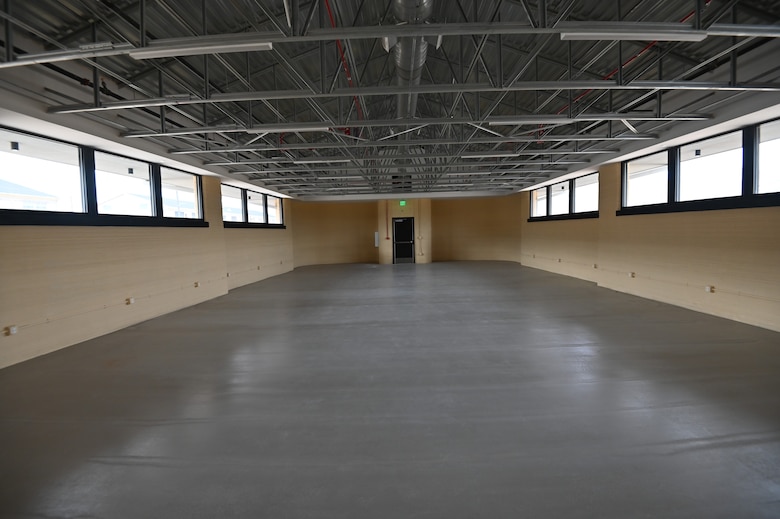 An interior view of the 3D-printed barracks constructed in 2024 as part of a prototype contract with the Defense Innovation Unit and the U.S. Army Corps of Engineers. This is the predecessor to the 10 buildings currently being built at Fort Bliss, Texas. The photo shows the dormitory-style living space inside the completed barracks. Each barracks also includes latrines, showering facilities, and washers and dryers.